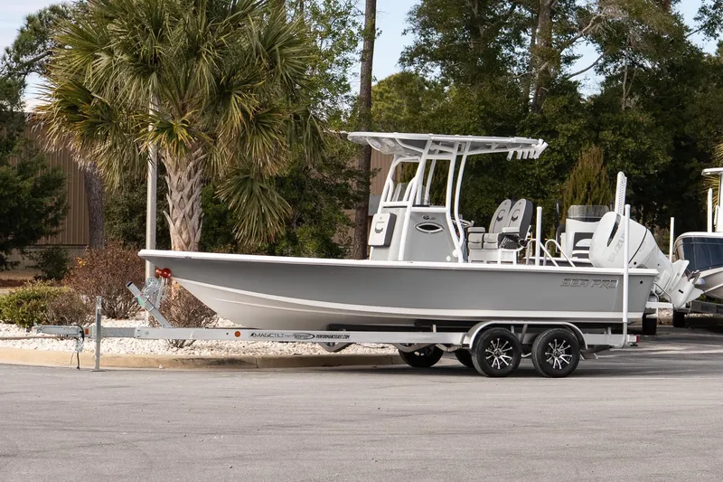The Image of 2025 Sea Pro 230 Bay boat on trailer, parked near palm trees. - 1