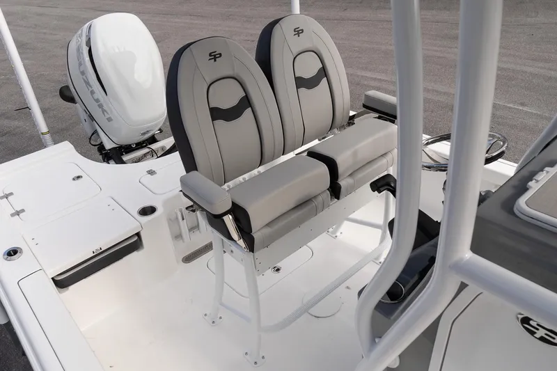 Slide: The Image of 2025 Sea Pro 230 Bay boat interior with dual seats and Suzuki outboard motor. - 10