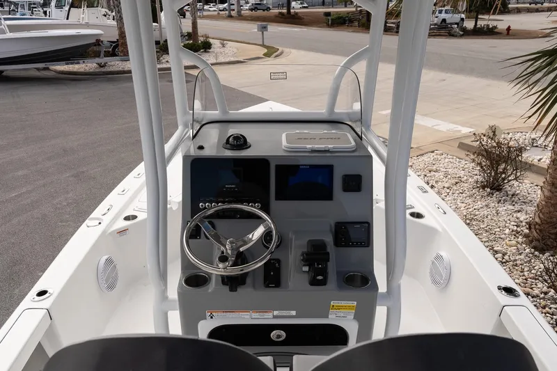 Slide: The Image of 2025 Sea Pro 230 Bay boat console with steering wheel and controls. - 8