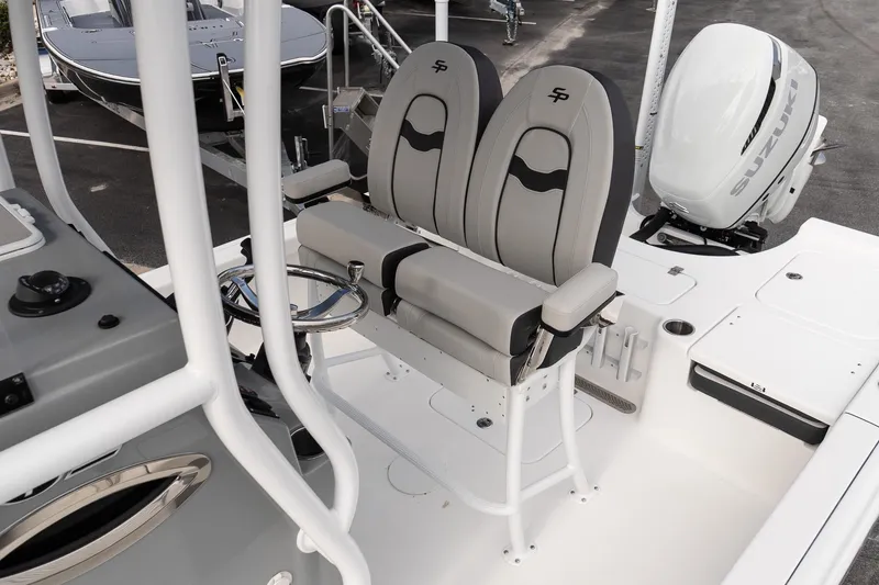 Slide: The Image of 2025 Sea Pro 230 Bay boat interior with dual seats and Suzuki outboard motor. - 9