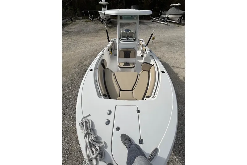 Slide: The Image of 2021 Tidewater 232 CC Adventure boat with beige seating and coiled rope on deck. - 6