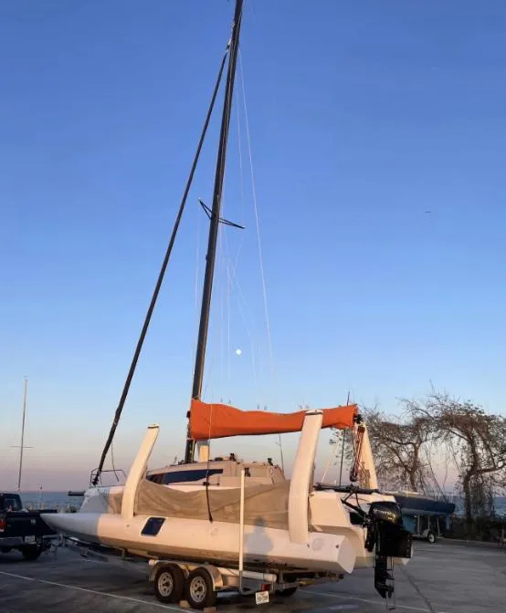 Slide: The Image of 2022 Corsair 880 Sport sailboat on trailer at sunset, ready for transport. - 21