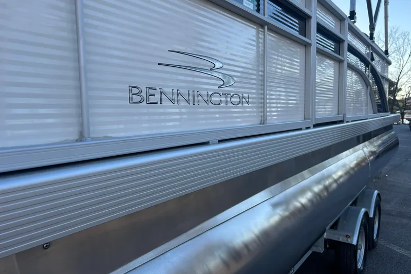 Slide: The Image of 2023 Bennington 23 SSR S pontoon boat side view with logo. - 11