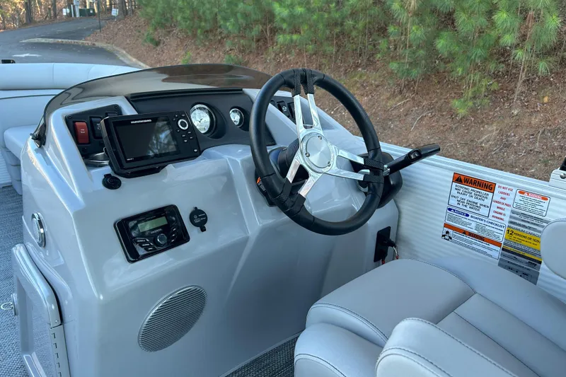 Slide: The Image of 2023 Bennington 23 SSR S boat dashboard with steering wheel and control panel. - 13