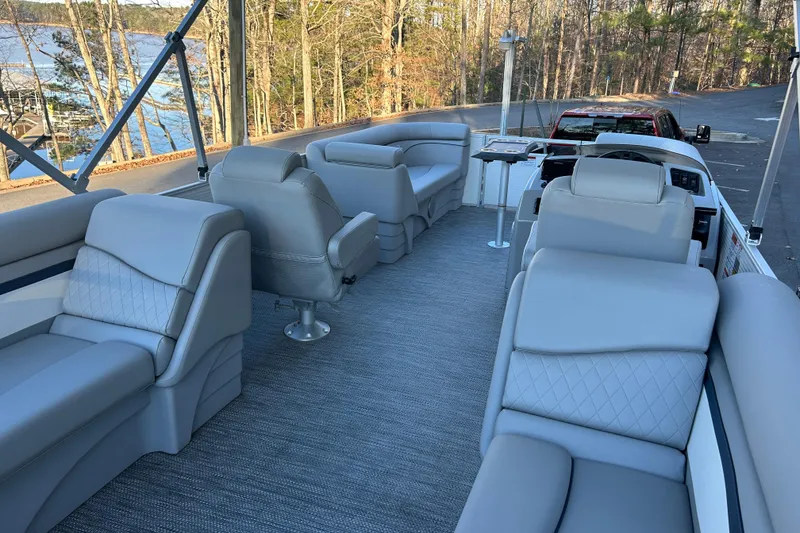 Slide: The Image of 2023 Bennington 23 SSR S pontoon boat interior with luxurious seating and lake view. - 16
