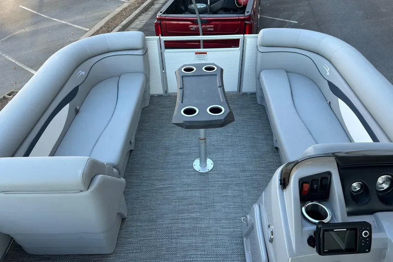 Slide: The Image of 2023 Bennington 23 SSR S pontoon boat interior with gray seating and central table. - 17