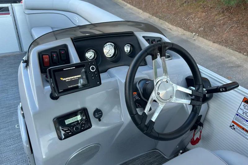 Slide: The Image of 2023 Bennington 23 SSR S boat dashboard with steering wheel and navigation controls. - 19