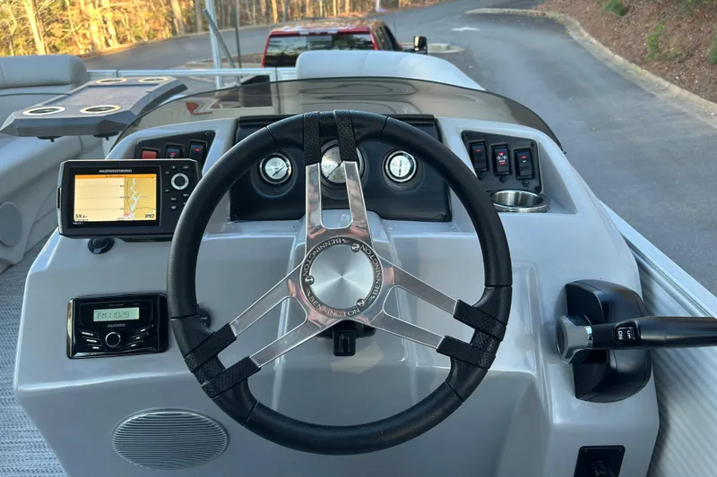 Slide: The Image of 2023 Bennington 23 SSR S boat dashboard with steering wheel and navigation system. - 21