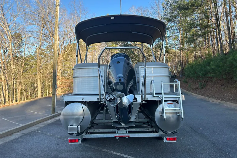 Slide: The Image of 2023 Bennington 23 SSR S pontoon boat rear view with canopy and motor. - 8