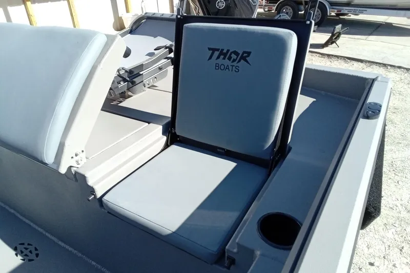 Slide: The Image of 2026 Thor 1900 Lake Hammer boat interior with branded seating and cup holder. - 11