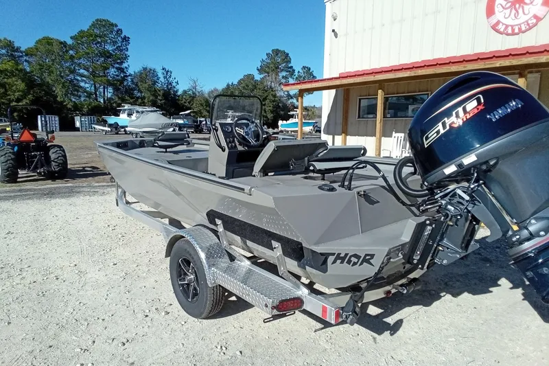 Slide: The Image of 2026 Thor 1900 Lake Hammer boat with Yamaha engine on trailer, parked outdoors. - 18