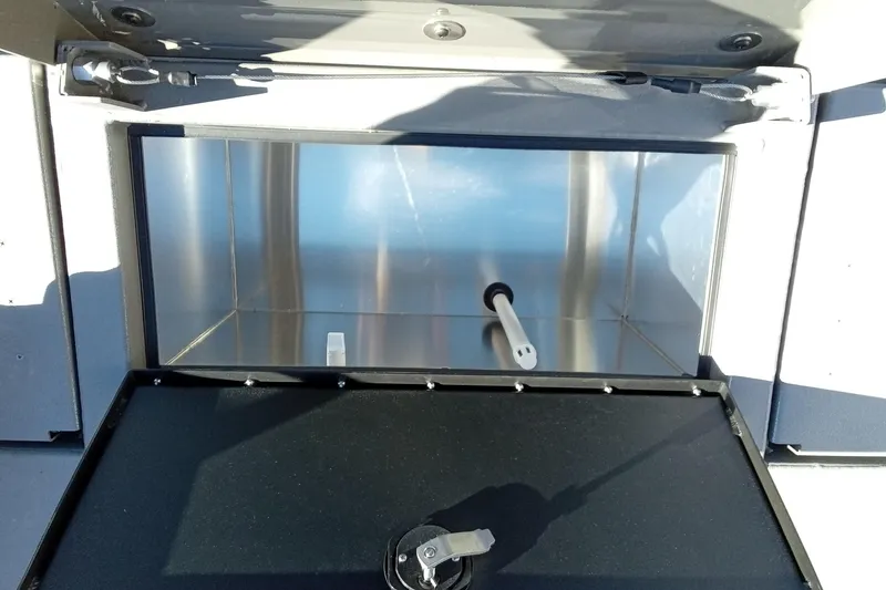 Slide: The Image of Open storage compartment in 2026 Thor 1900 Lake Hammer vehicle, featuring a sleek metallic interior. - 20