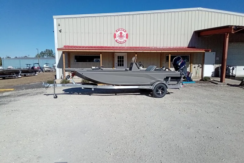Slide: The Image of 2026 Thor 1900 Lake Hammer boat on trailer outside a warehouse. - 3