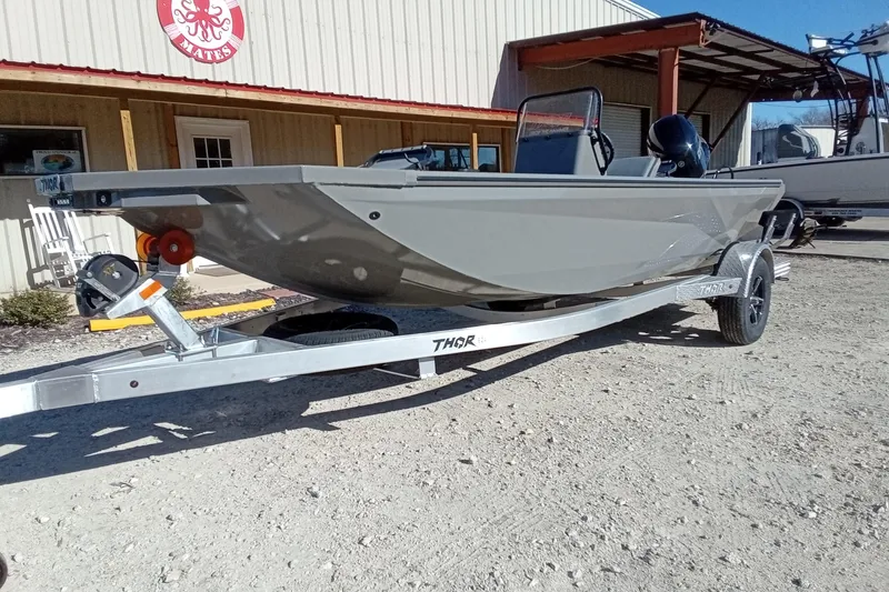 Slide: The Image of 2026 Thor 1900 Lake Hammer boat on trailer outside a building. - 4