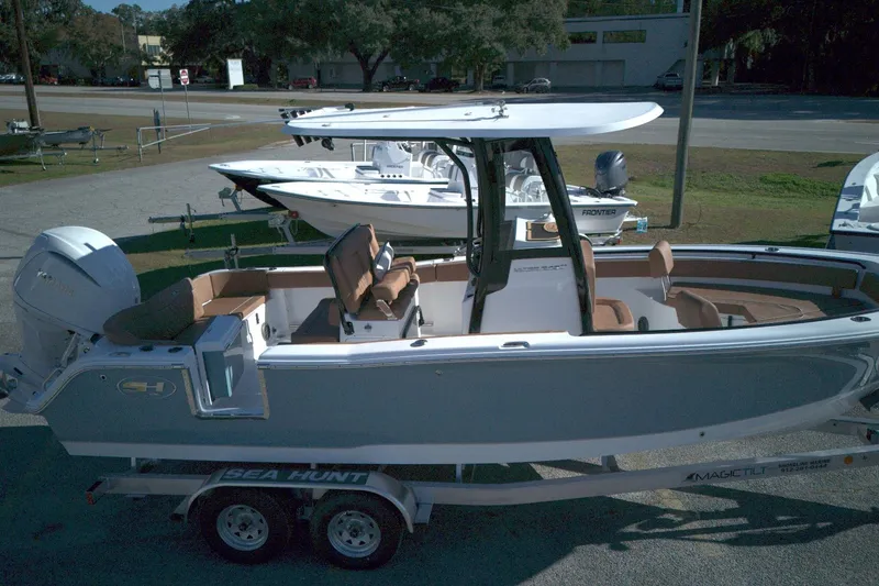 The Image of 2026 Sea Hunt Ultra 245 SE boat on trailer, parked outdoors. - 0