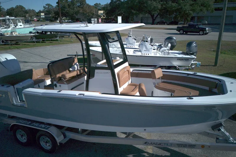Slide: The Image of 2026 Sea Hunt Ultra 245 SE boat on trailer, featuring sleek design and spacious seating. - 1