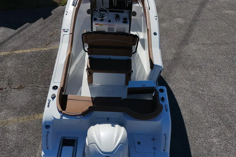 Slide: The Image of 2026 Sea Hunt Ultra 245 SE boat interior with seating and steering console. - 3
