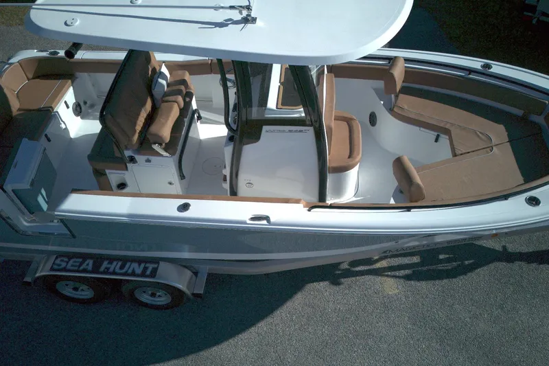 Slide: The Image of 2026 Sea Hunt Ultra 245 SE boat with brown seating and white deck. - 4