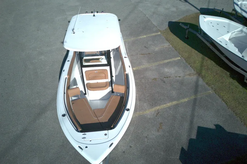 Slide: The Image of 2026 Sea Hunt Ultra 245 SE boat, aerial view, parked on pavement. - 5