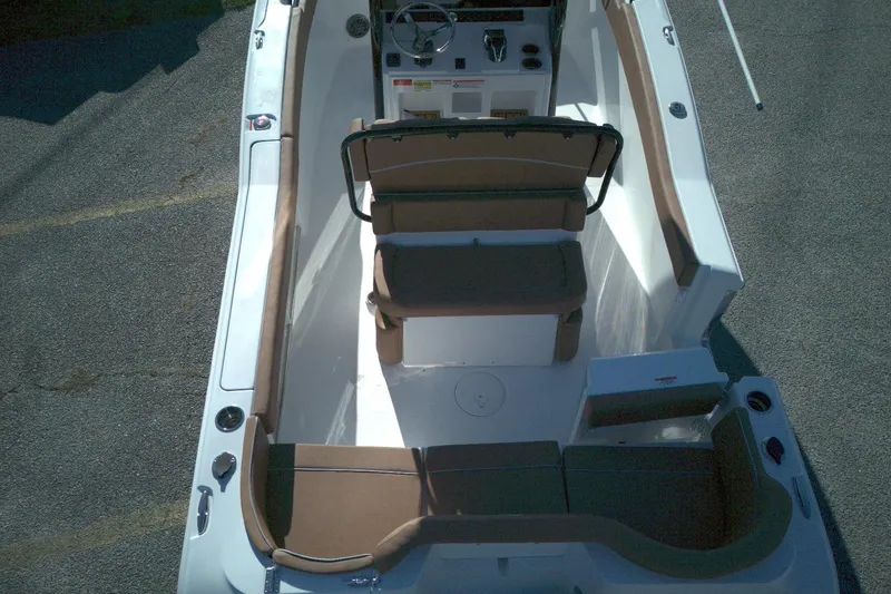 Slide: The Image of 2026 Sea Hunt Ultra 245 SE boat interior with brown seating and steering console. - 8