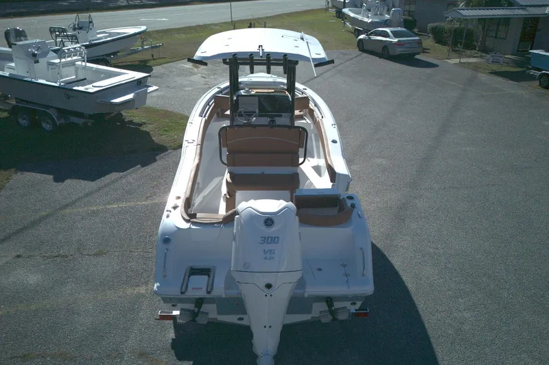 Slide: The Image of 2026 Sea Hunt Ultra 245 SE boat with Yamaha 300 V6 engine, parked outdoors. - 9