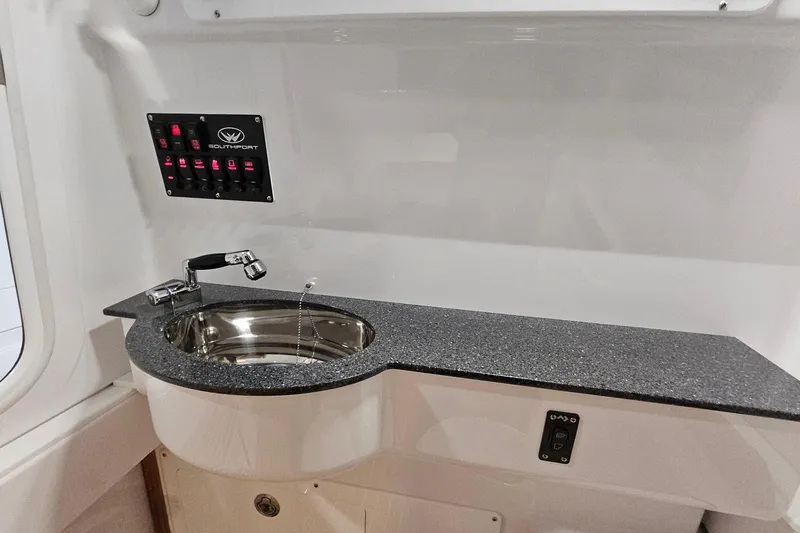 Slide: The Image of 2026 Southport 30 FE boat interior with wooden steps and storage compartments. - 12