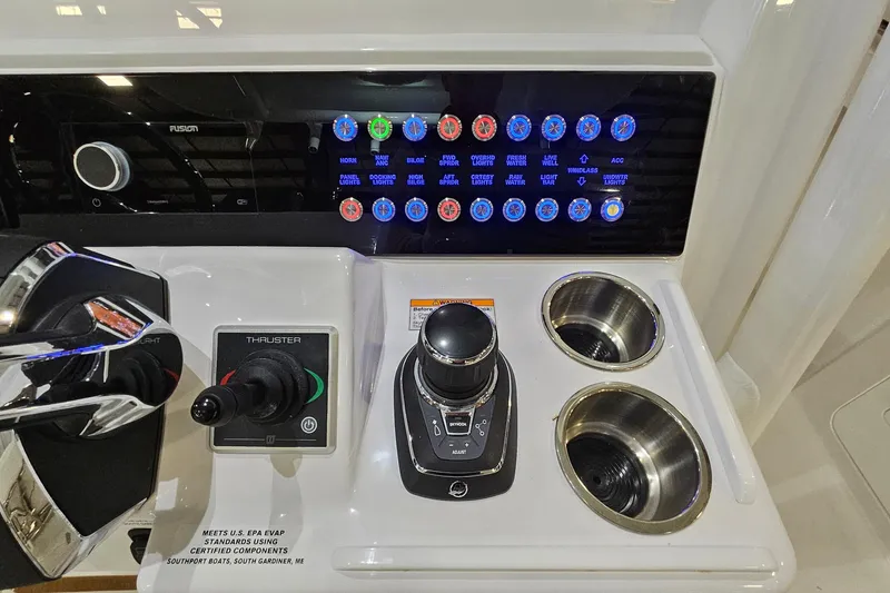 Slide: The Image of 2026 Southport 30 FE boat dashboard with controls and steering wheel. - 17