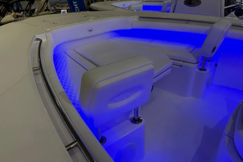 Slide: The Image of 2026 Southport 30 FE boat displayed with colorful lighting on red carpet. - 2