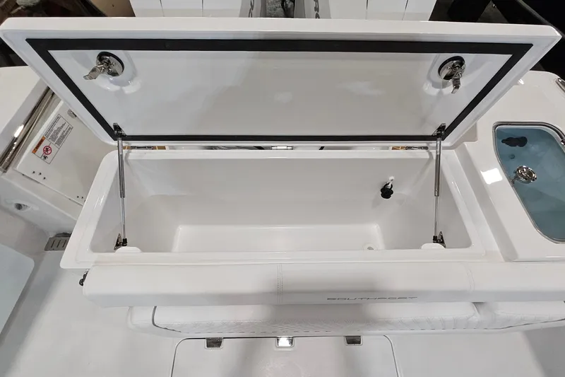 Slide: The Image of Interior of 2026 Southport 30 FE boat, featuring white upholstery and storage compartment. - 28