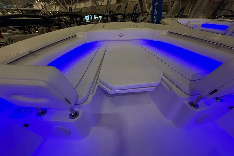 Slide: The Image of 2026 Southport 30 FE boat interior with table and seating area. - 3