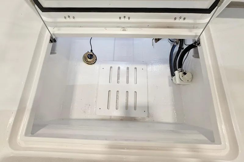 Slide: The Image of 2026 Southport 30 FE boat with livewell and Mercury engine in a showroom. - 31