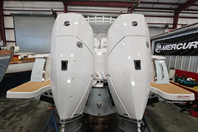 Slide: The Image of 2026 Southport 30 FE boat with dual Mercury outboard engines in a showroom. - 33