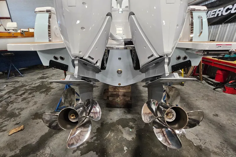 Slide: The Image of 2026 Southport 30 FE boat with dual outboard engines in a workshop setting. - 34