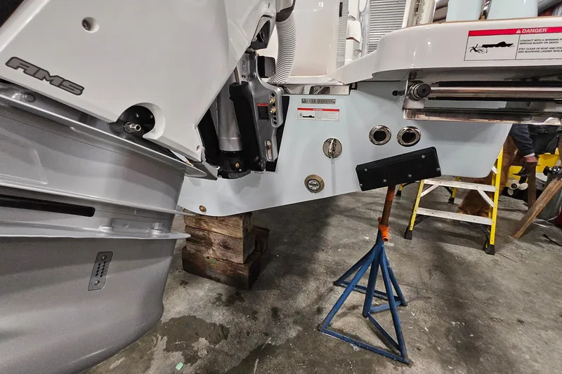 Slide: The Image of 2026 Southport 30 FE boat with dual outboard engines in a workshop setting. - 35