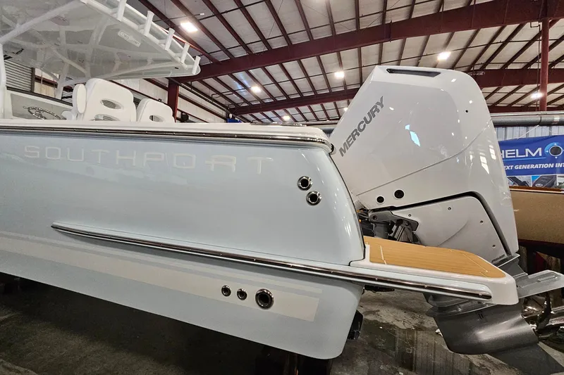 Slide: The Image of 2026 Southport 30 FE boat side view in a showroom setting. - 38