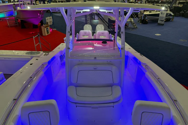 Slide: The Image of 2026 Southport 30 FE boat interior with seating and table in a storage facility. - 4