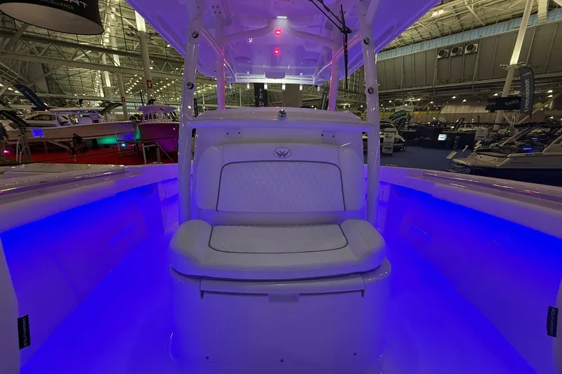 Slide: The Image of 2026 Southport 30 FE boat interior with white seating and table in a storage facility. - 5