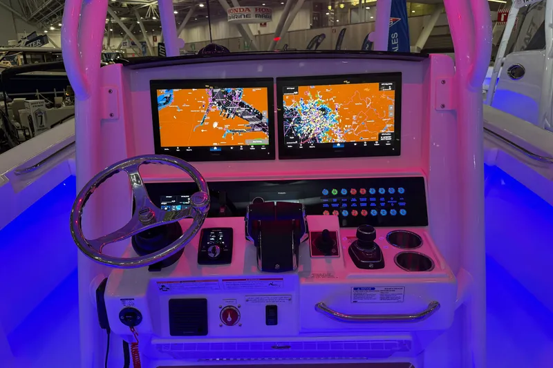 Slide: The Image of 2026 Southport 30 FE boat interior in a showroom with other boats. - 8