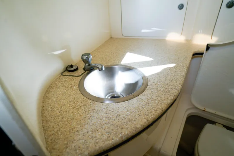 Slide: The Image of 2003 Intrepid 310 Walkaround boat interior with sink and countertop. - 28