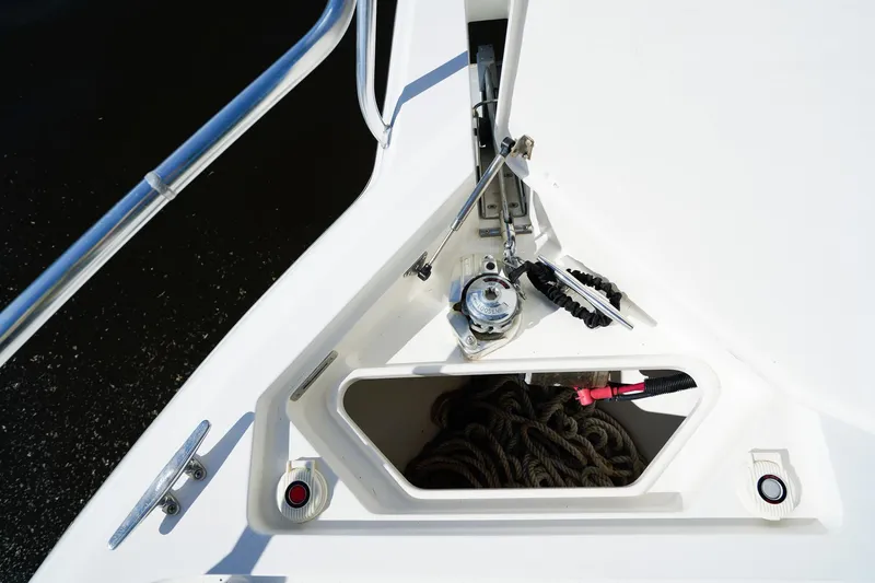 Slide: The Image of Anchor compartment of a 2003 Intrepid 310 Walkaround boat with ropes and winch. - 33