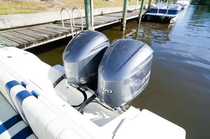 Slide: The Image of 2003 Intrepid 310 Walkaround with twin Yamaha outboard engines docked by the water. - 5