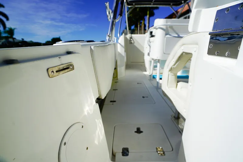 Slide: The Image of 2003 Intrepid 310 Walkaround boat interior with sleek white design and modern fittings. - 6