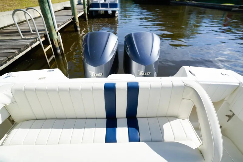 Slide: The Image of 2003 Intrepid 310 Walkaround boat with twin 300 horsepower engines at dock. - 7