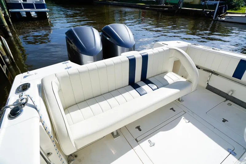 Slide: The Image of 2003 Intrepid 310 Walkaround boat with dual engines and white seating. - 8