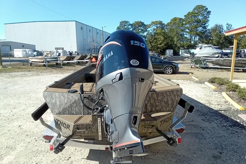 Slide: The Image of 2026 Thor 1900 Lake Hammer boat with Yamaha 150 outboard motor in a marina setting. - 11