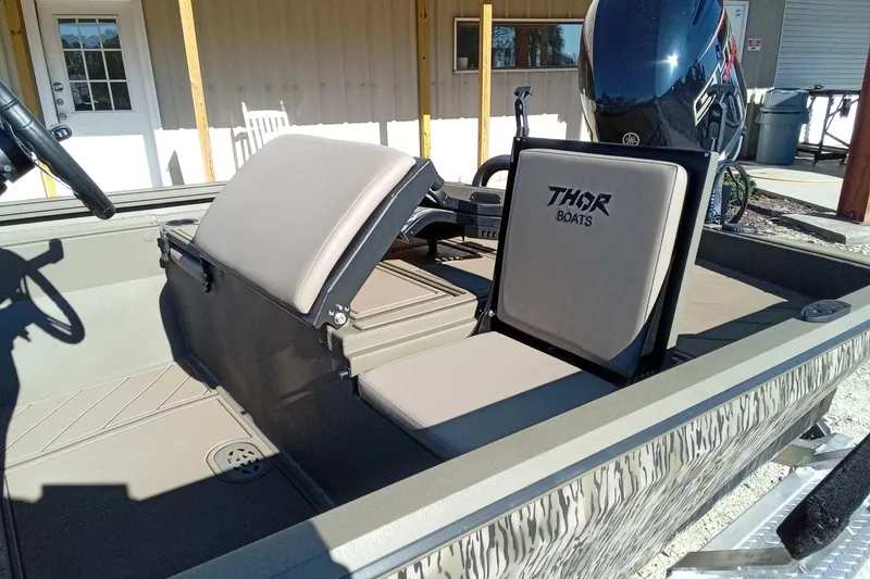Slide: The Image of 2026 Thor 1900 Lake Hammer boat interior with seating and steering wheel. - 14