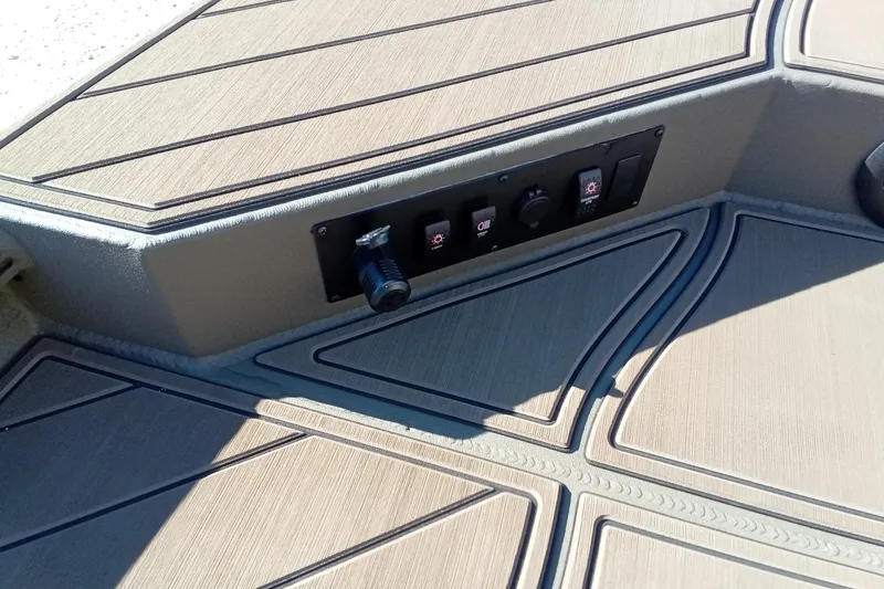 Slide: The Image of Control panel on 2026 Thor 1900 Lake Hammer boat deck with textured flooring. - 24