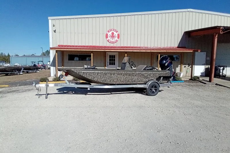 Slide: The Image of 2026 Thor 1900 Lake Hammer boat on trailer outside a warehouse. - 4