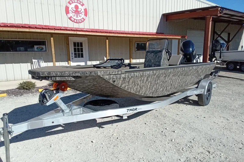 Slide: The Image of 2026 Thor 1900 Lake Hammer boat on trailer outside a building. - 5