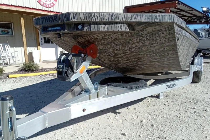 Slide: The Image of 2026 Thor 1900 Lake Hammer boat on trailer, parked outside a building. - 6